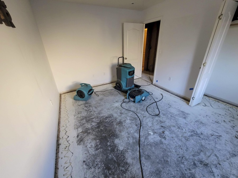 Sewage cleanup equipment drying and restoring a stripped residential room after water damage cleanup